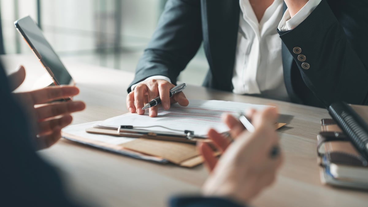 Business professionals in an office environment discussing workplace support